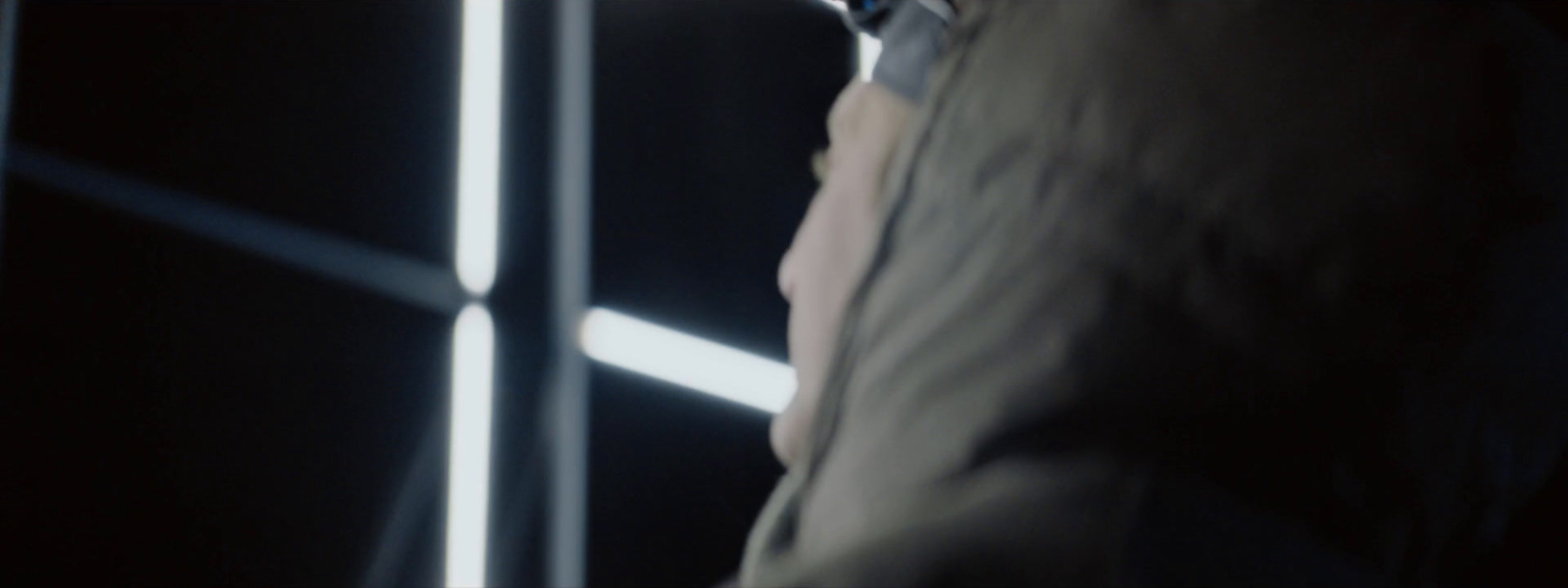 a man standing in front of a mirror in a dark room