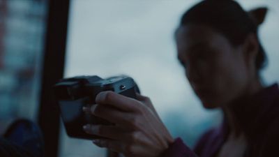 a woman holding a camera in her hands