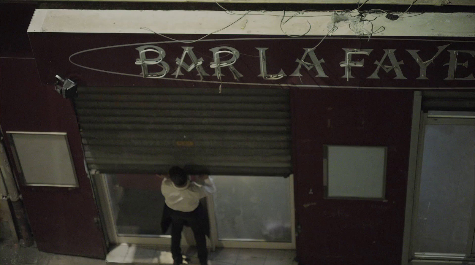 a man standing in front of a bar la fave