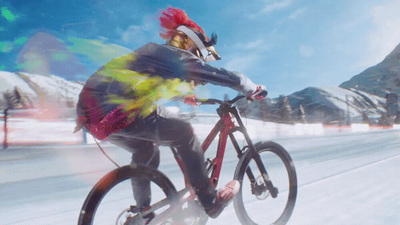 a man riding a bike down a snow covered road