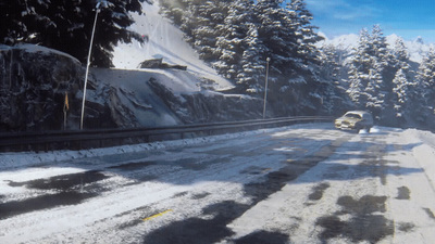 a car driving down a snow covered road