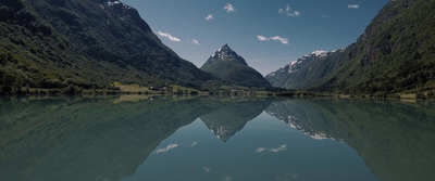 a mountain range is reflected in a lake