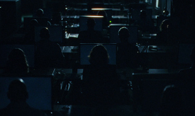 a group of people sitting in a dark room