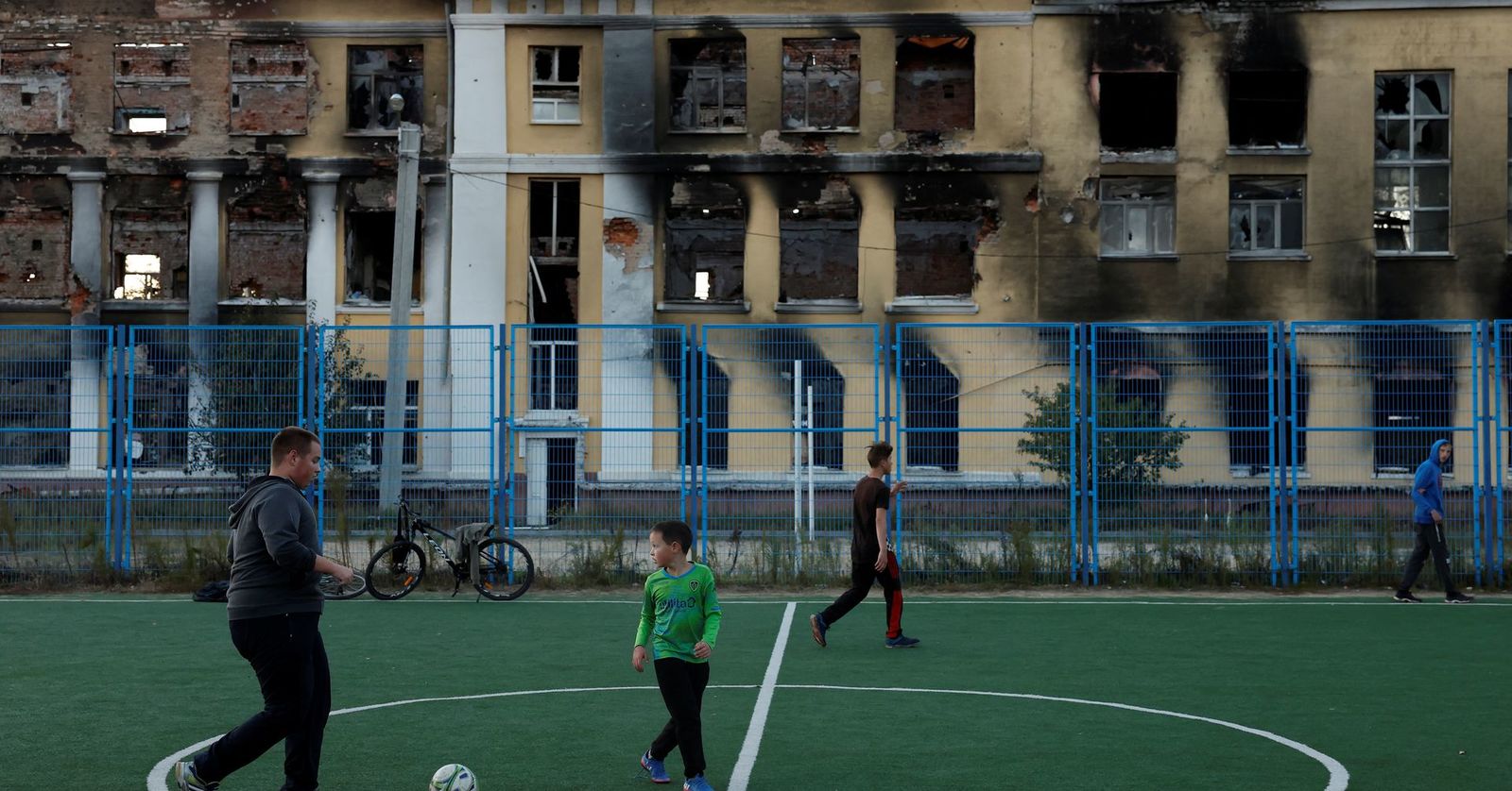 a group of people on a field with a soccer ball