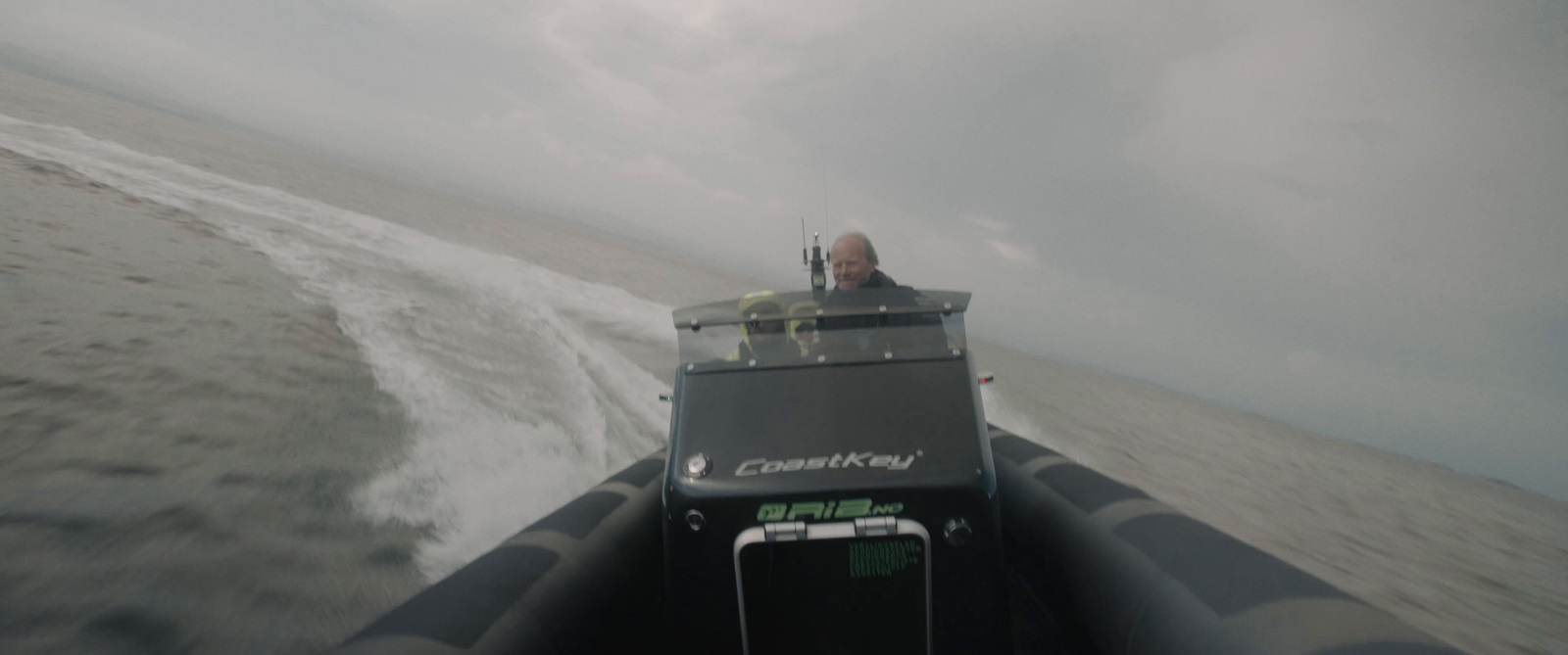 a man is driving a boat in the ocean