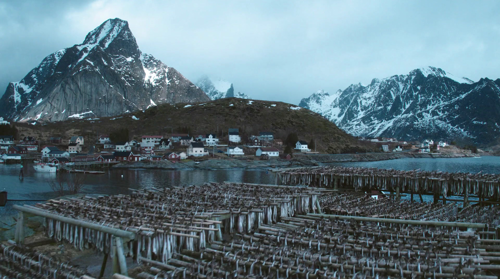 a group of wooden poles sitting next to a body of water