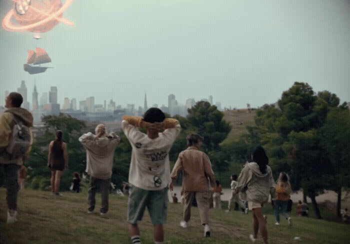 a group of people flying a kite in a park