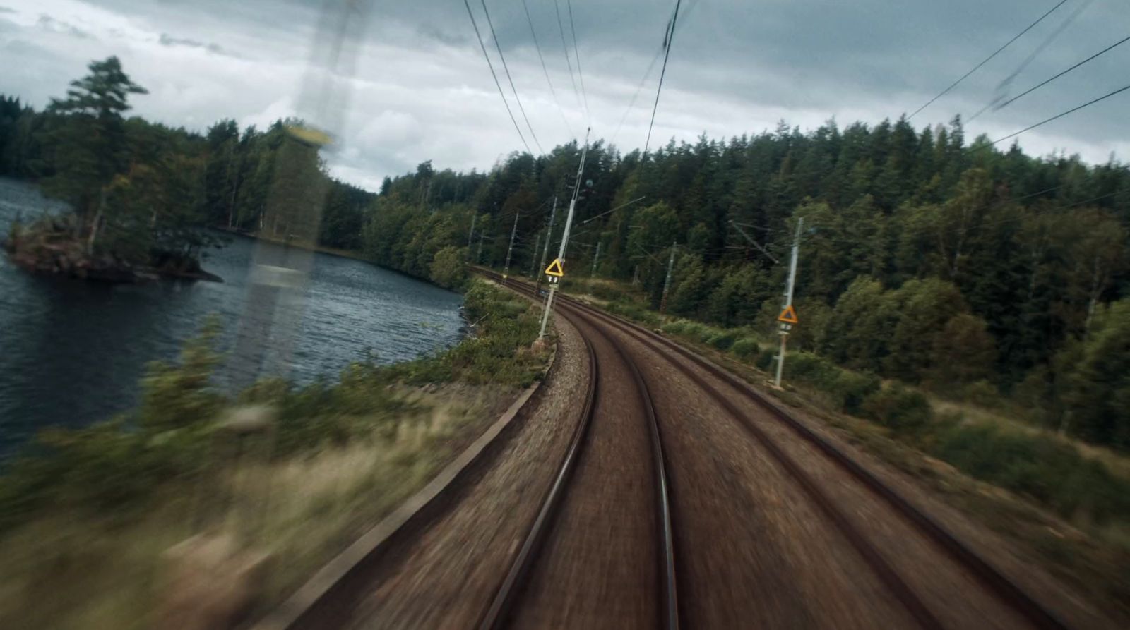 a view of a train track and a body of water