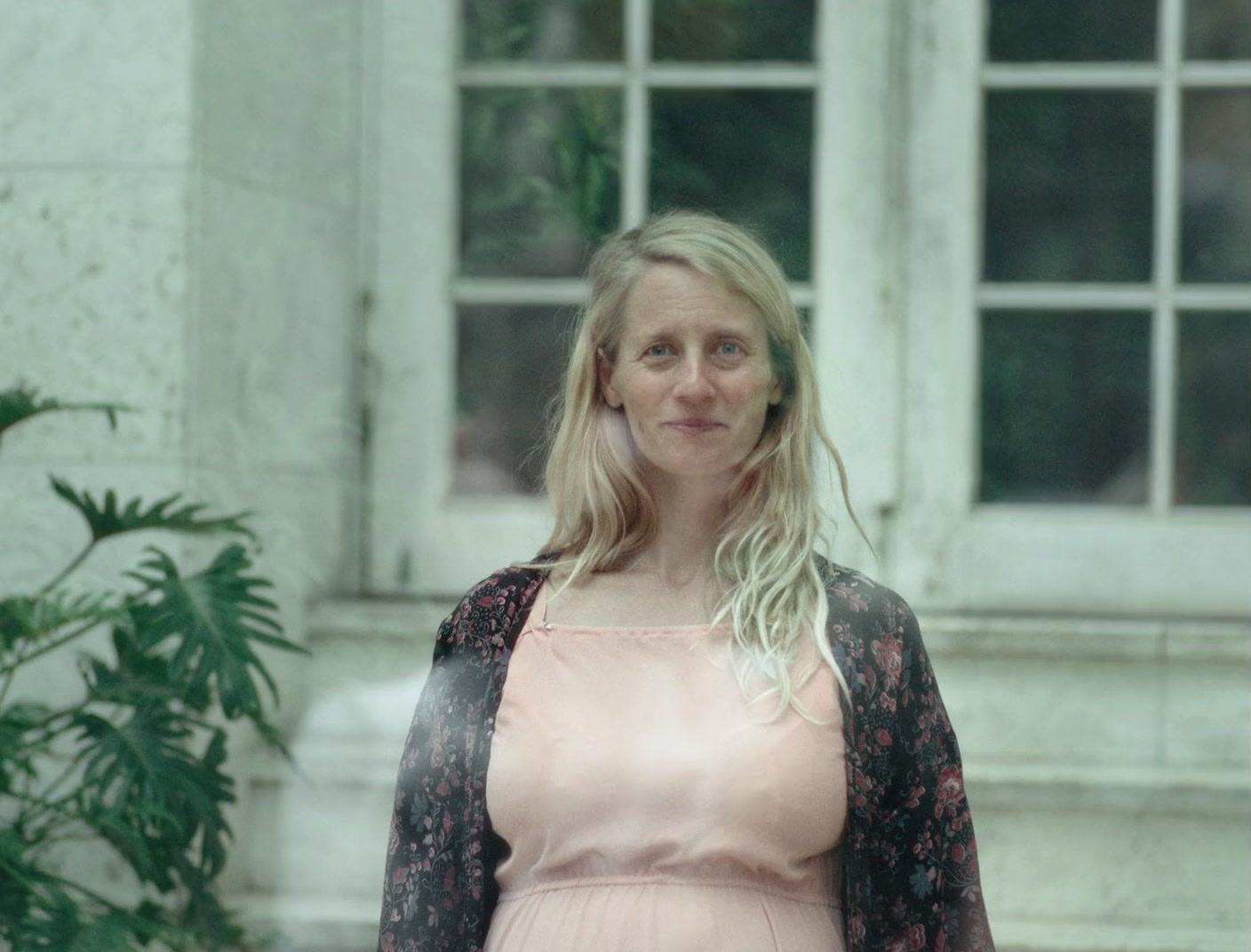 a woman standing in front of a building