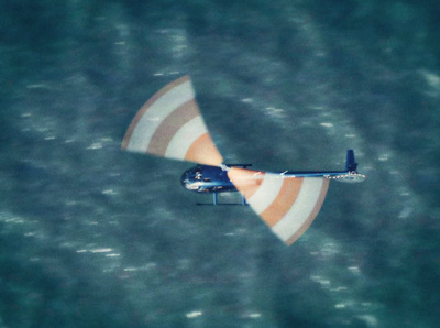 a small airplane flying over a body of water