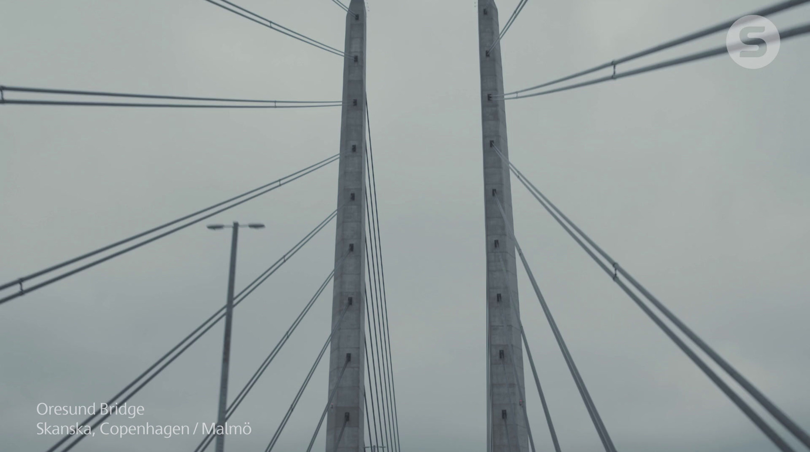 a view of the top of a bridge in the rain