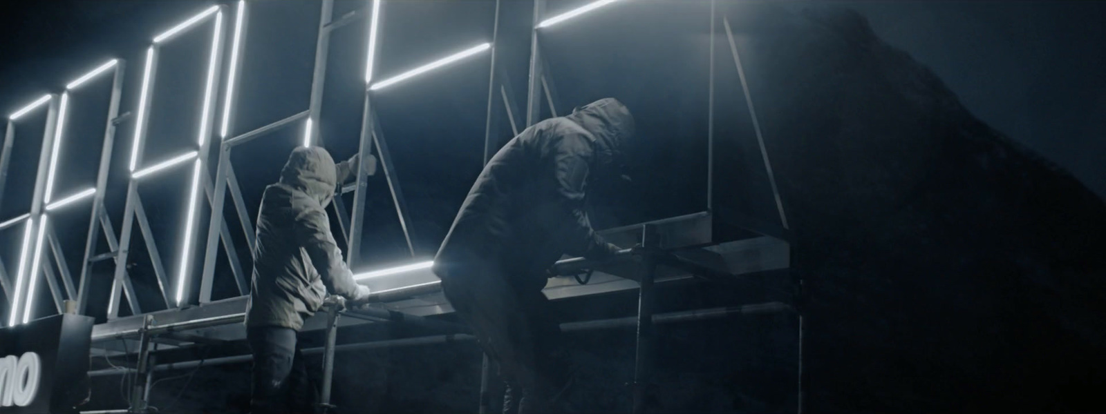 a man standing on a scaffold in the dark