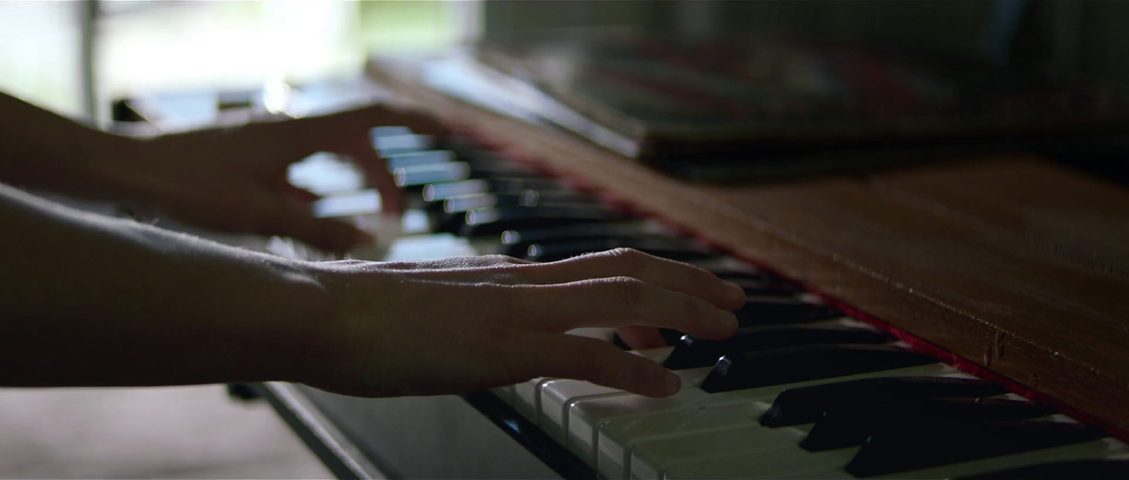 a person playing a piano with their hands