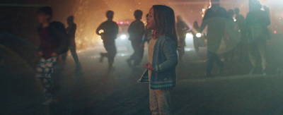 a group of people standing around in the dark