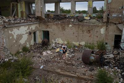 a woman standing in a run down building