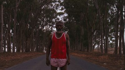 a man riding a skateboard down a road