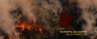a red fire extinguisher flying over a forest filled with fire