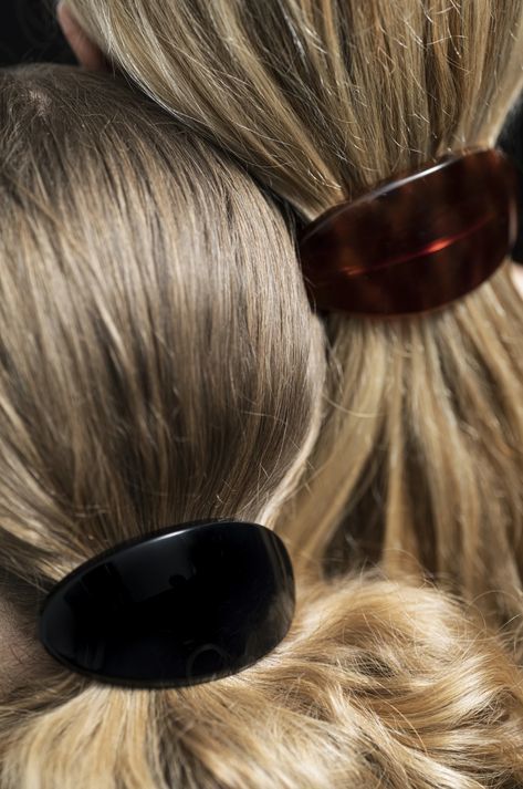 a close up of a woman's hair with a pair of sunglasses on her