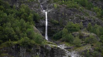 a waterfall is flowing down the side of a mountain