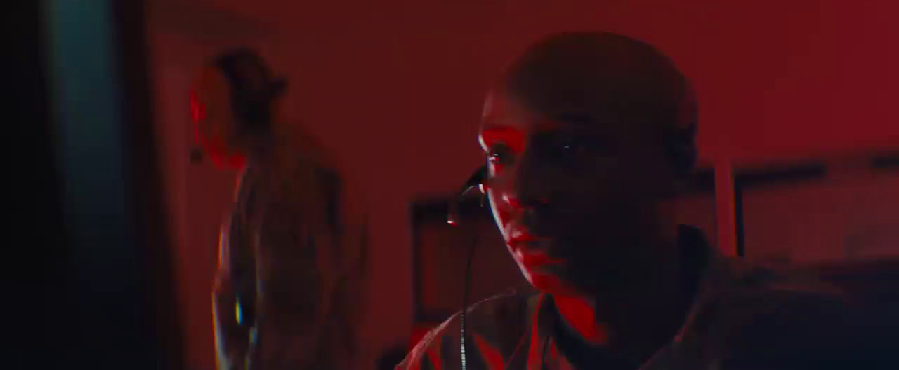 a man standing in a room with a red light