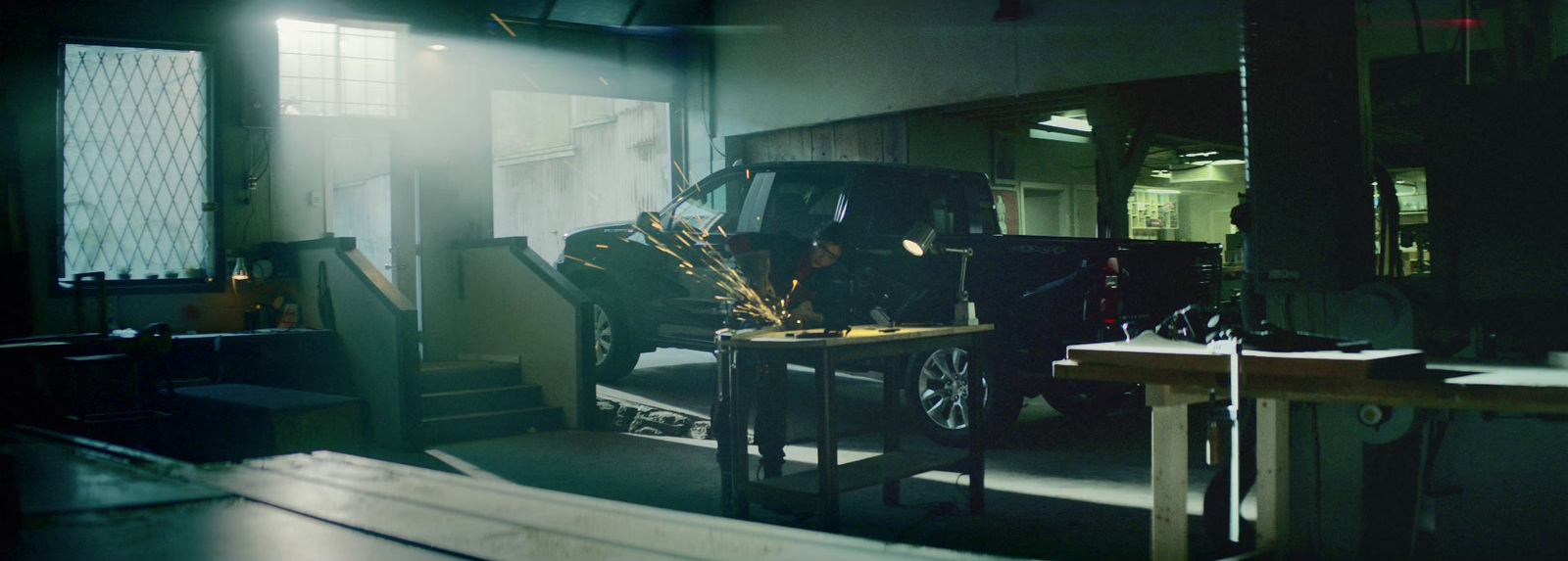 a car parked inside of a garage next to a table