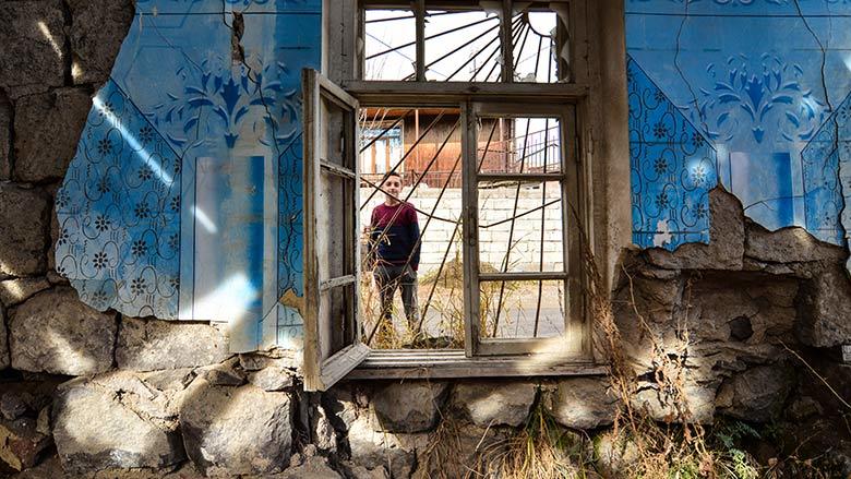 a man standing in a window of an old building