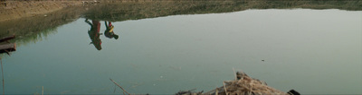 two giraffes are standing in the water