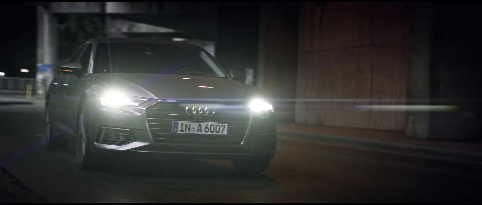 a car driving down a street at night