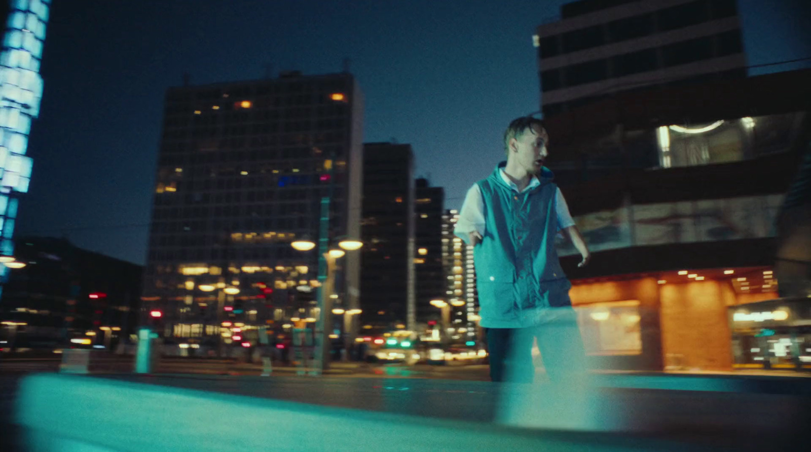 a man walking down a street at night