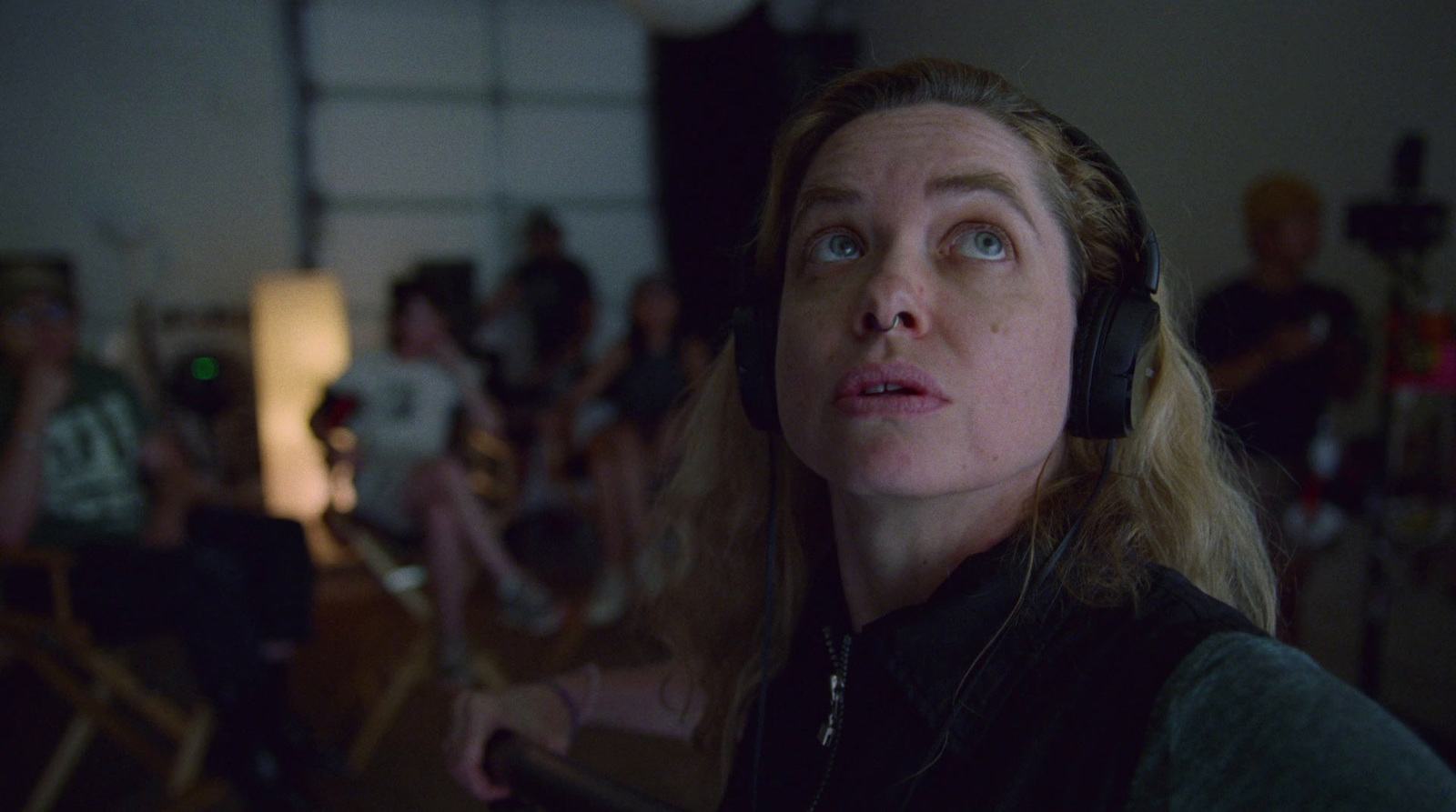 a woman with headphones in front of a group of people