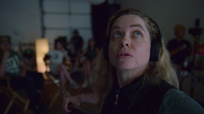 a woman with headphones in front of a group of people