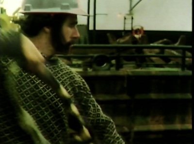 a man wearing a hard hat standing in a factory