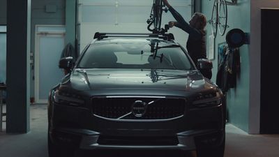 a woman working on a car in a garage