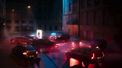 a group of cars driving down a street at night