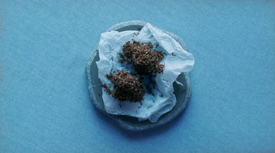 a small bowl filled with food on top of a blue table