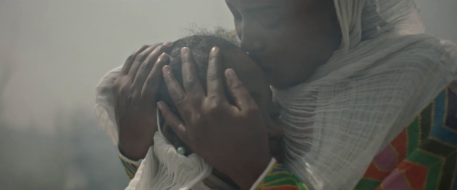 a woman holding a baby in her arms