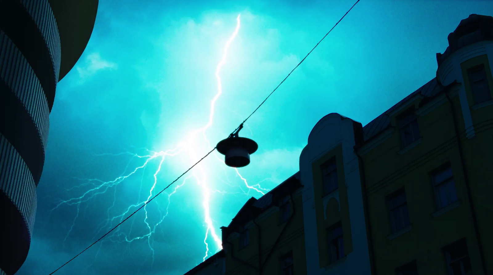 a street light and a building with a lot of lightning