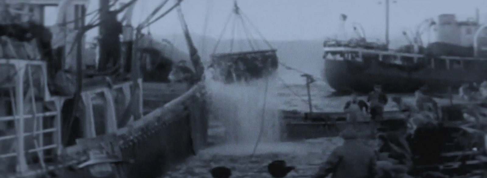 a black and white photo of several boats in the water