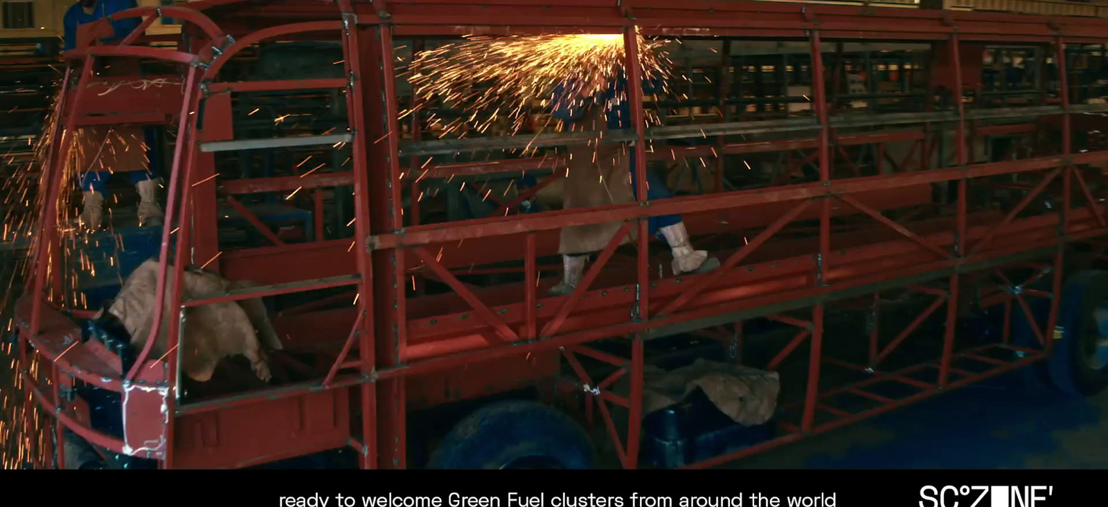 a man welding a piece of metal in a factory