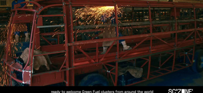 a man welding a piece of metal in a factory