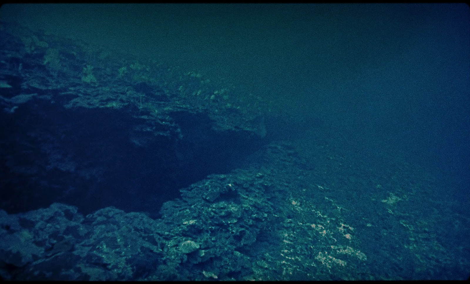 an underwater view of a deep blue ocean