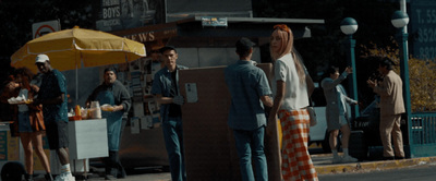 a group of people standing on the side of a road