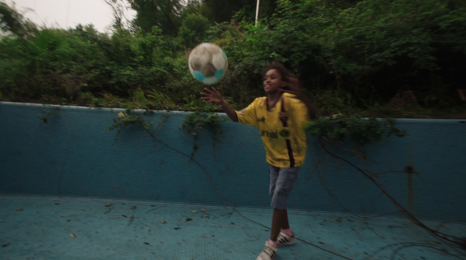 a young girl is playing with a ball