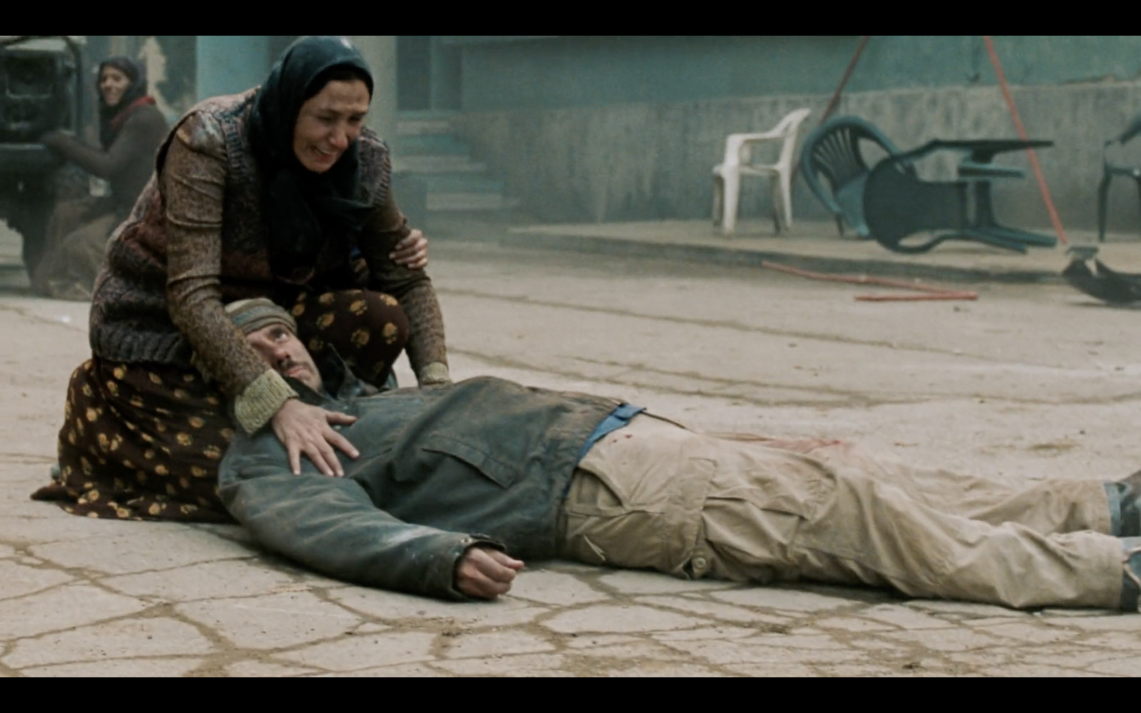 a man laying on the ground next to a woman