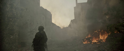 a man standing in the middle of a street in front of a fire