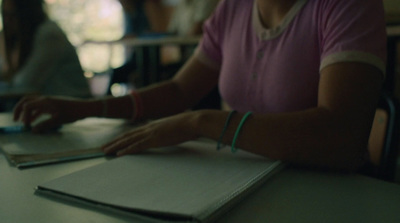 a woman sitting at a table using a laptop computer