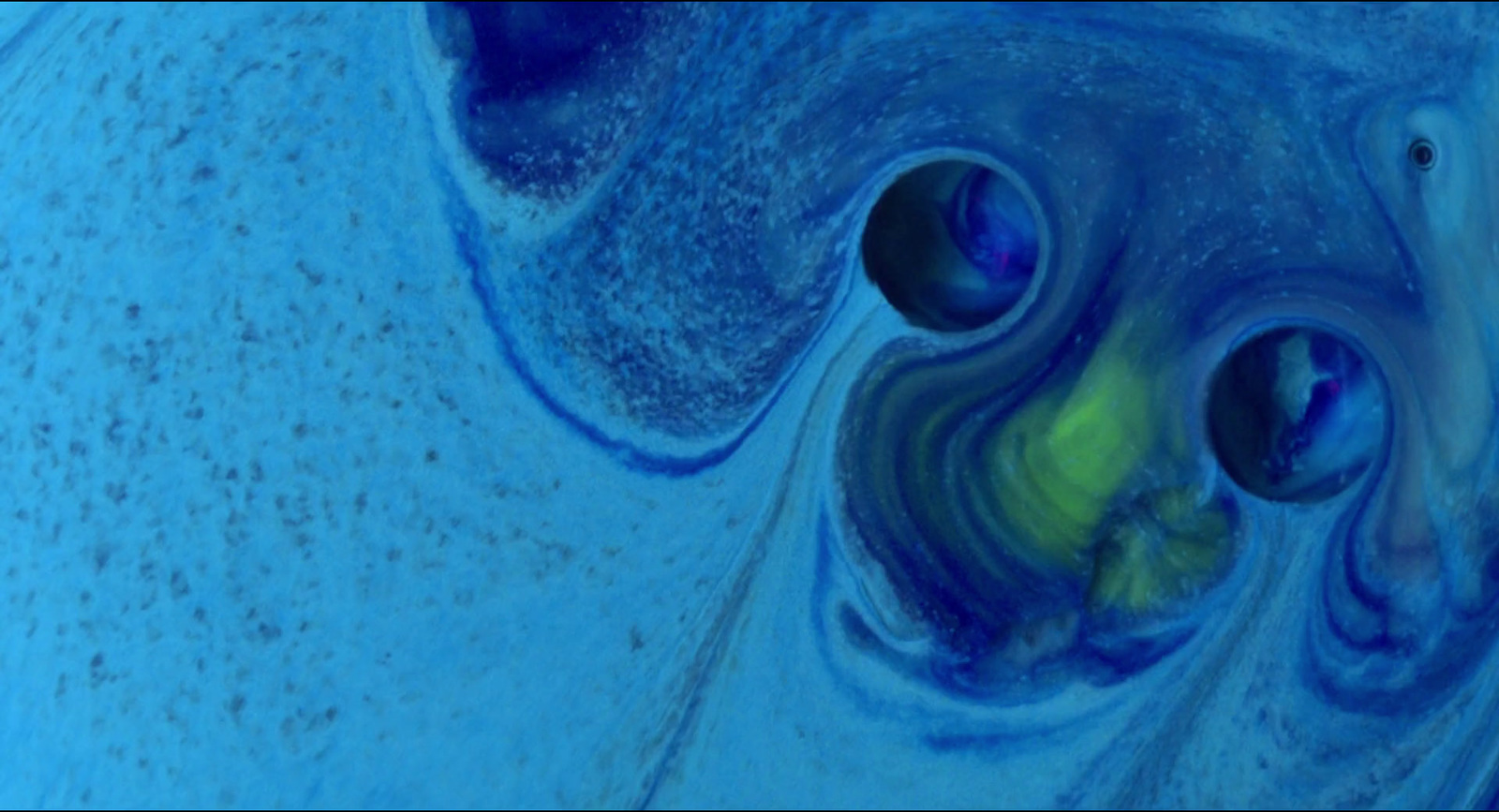 a close up of a blue and yellow substance