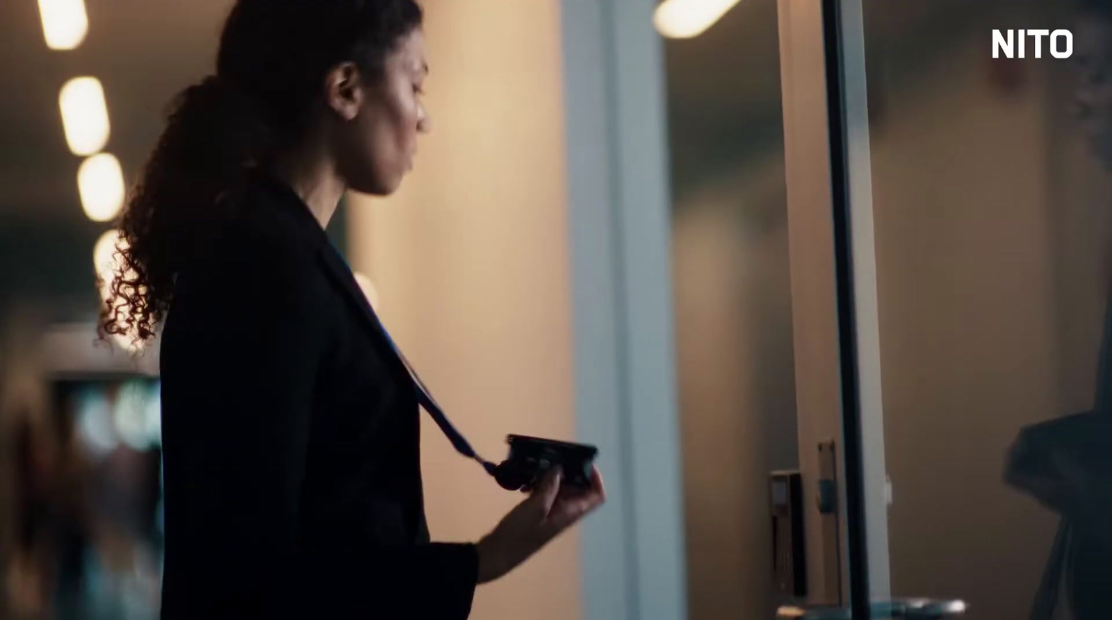 a woman standing in front of a mirror holding a camera