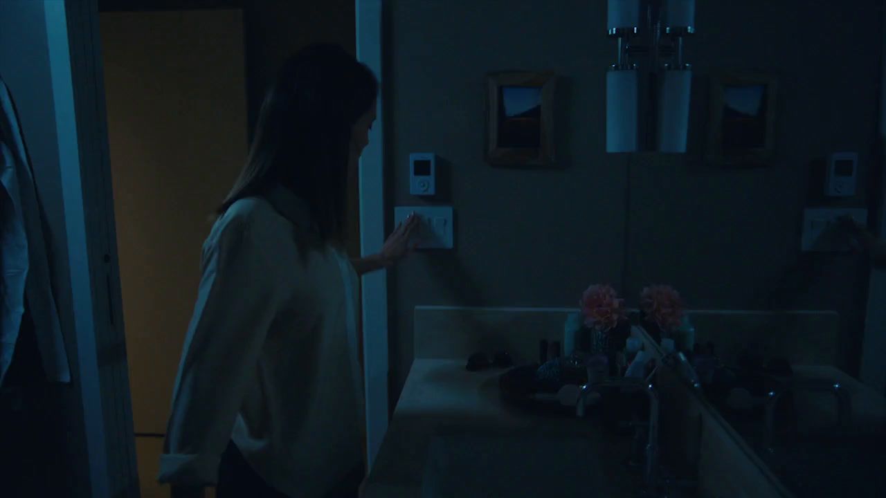 a woman standing in front of a bathroom sink