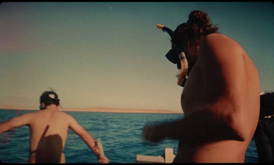 a couple of men standing on top of a boat